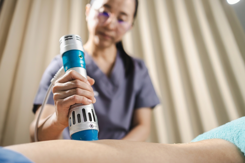 A physiotherapist at Equilibrium gives a client shockwave therapy.