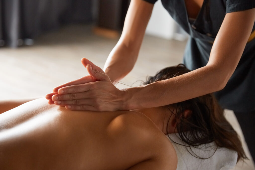 An active woman receives a therapeutic massage at Equilibrium.