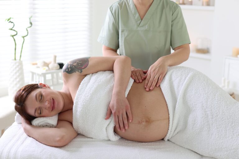 Woman receiving a prenatal massage from massage therapist at Equilibrium Therapeutics